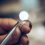 Different goldsmiths tools on the jewelry workplace. Jeweler at work in jewelry. Desktop for craft jewelry making with professional tools. Close up view of tools.